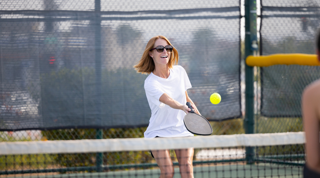 Image of woman dinking pickleball